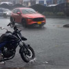 Un fuerte aguacero cayó en la tarde de este viernes en Manizales. En la foto, un carro pasa por encima de una tapa de alcantarilla que se levanta por la fuerza del agua en el sector de Los Agustinos.