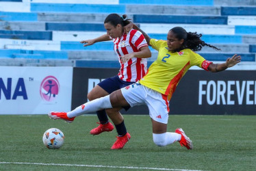 La jugadora de Colombia, Mary Alvarez (d), disputa el balón con la jugadora de Paraguay, Zunilda Coronel (i), por el Sudamericano Femenino sub-20 este domingo, en la ciudad de Guayaquil (Ecuador). 