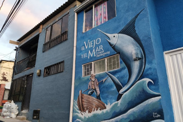 Portada de El viejo y el mar pintada en una fachada de La Pradera, obra de Felipe Chiquito, artista local de Villamaría.