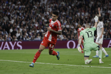 El delantero colombiano del Bayern Munich Luis Díaz celebra tras anotar el primer gol del equipo durante el encuentro correspondiente a la ida de los cuartos de final de la Liga de Campeones que disputan este martes Real Madrid y Bayern Munich en el estadio Santiago Bernabéu, en Madrid. 