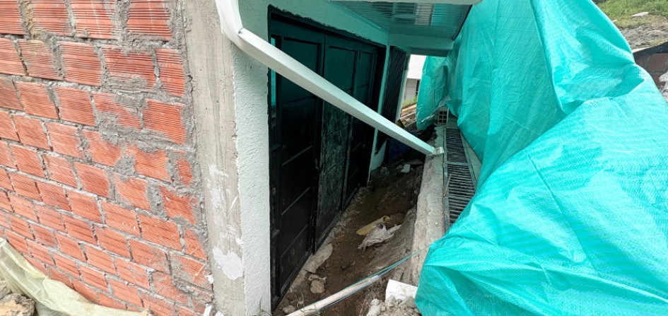 Esta es parte de la fachada de la casa que está cubierta con una lona verde. El inmueble se hundió aproximadamente 120 centímetros. 